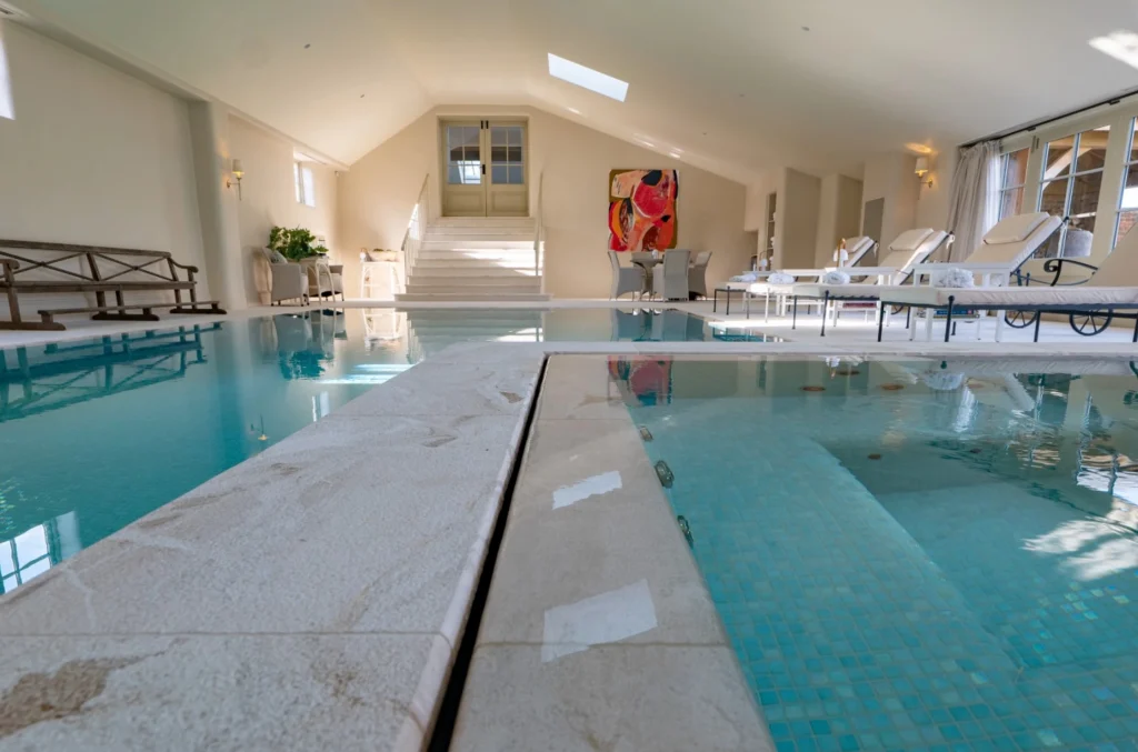 Luxurious indoor swimming pool facility with vaulted ceiling