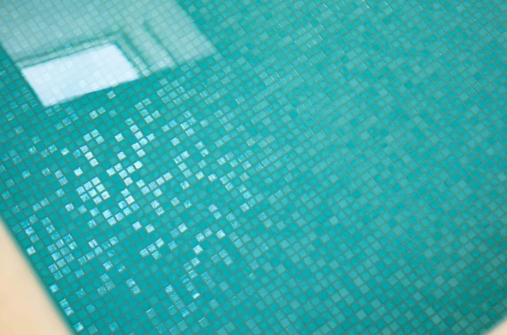 Turquoise mosaic pool tiles with white lane marker