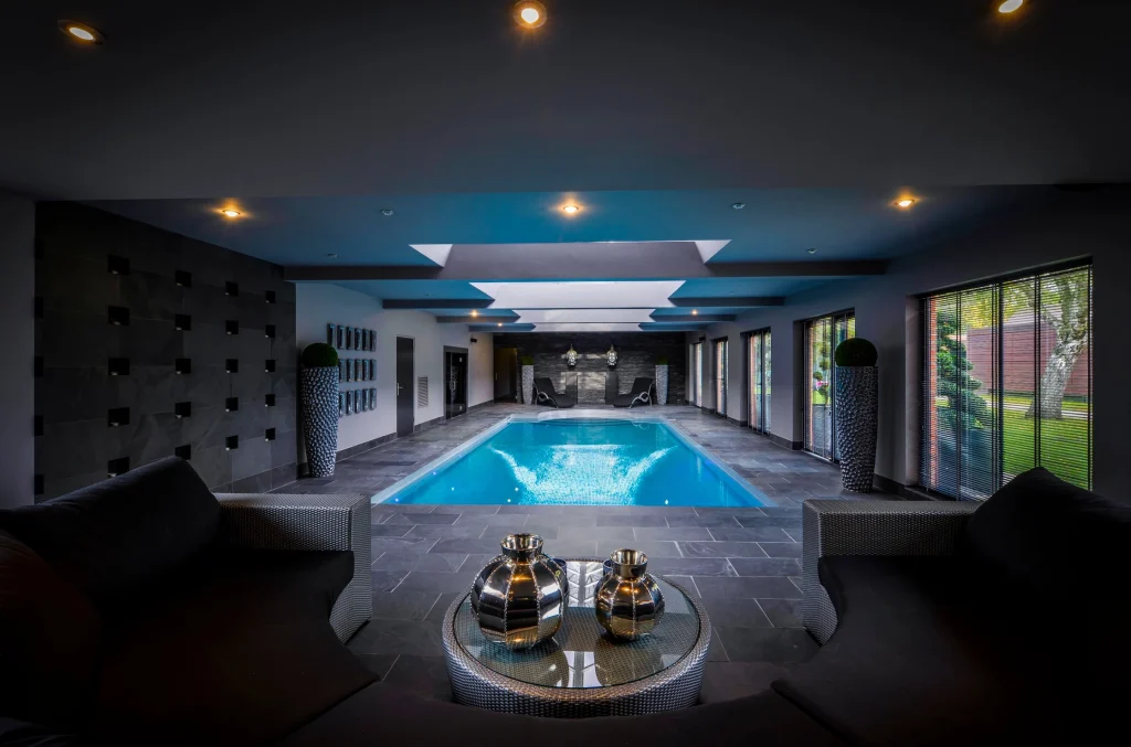 Luxury indoor swimming pool with modern architectural design and lighting