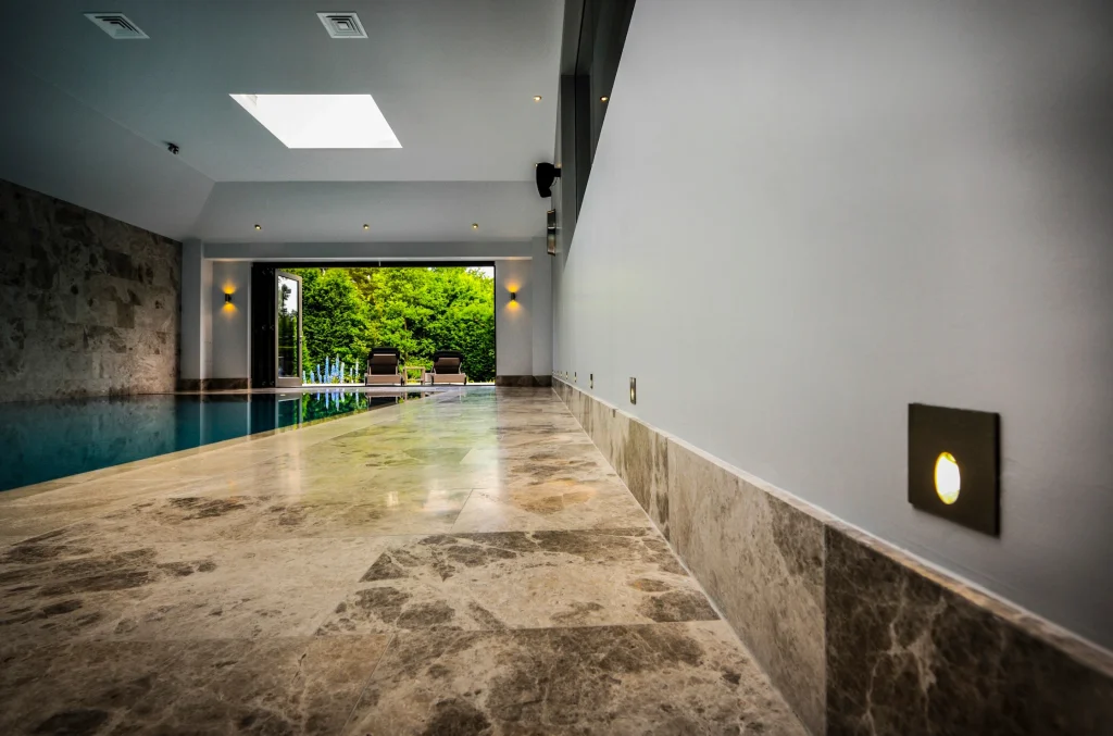 Modern indoor swimming pool with skylight and garden view