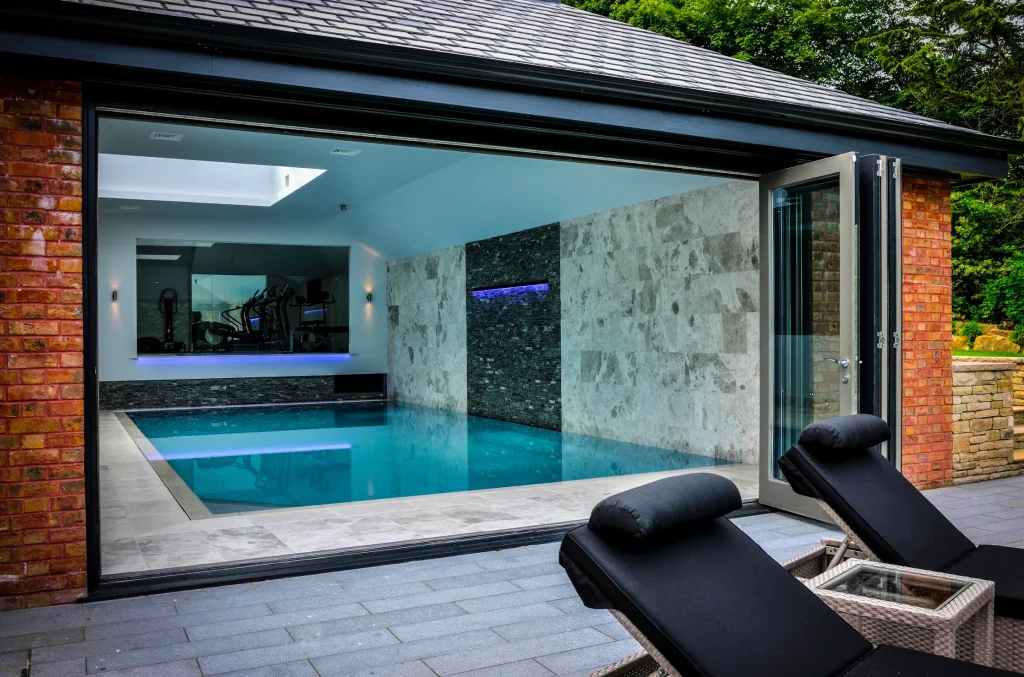 Modern indoor swimming pool with turquoise water and contemporary architecture