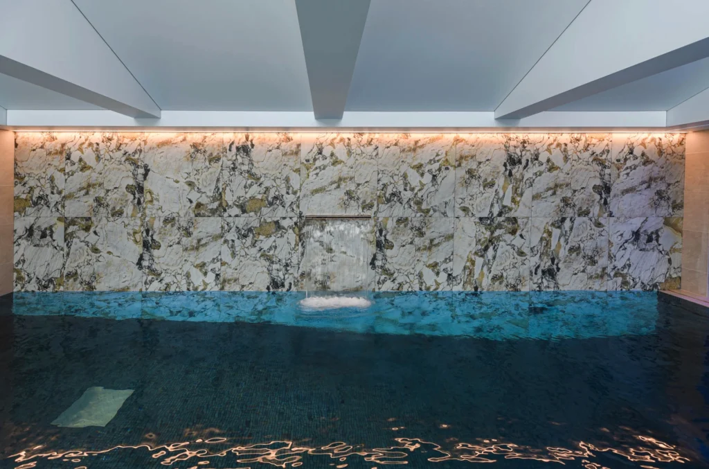 Modern interior with marble wall and turquoise water feature