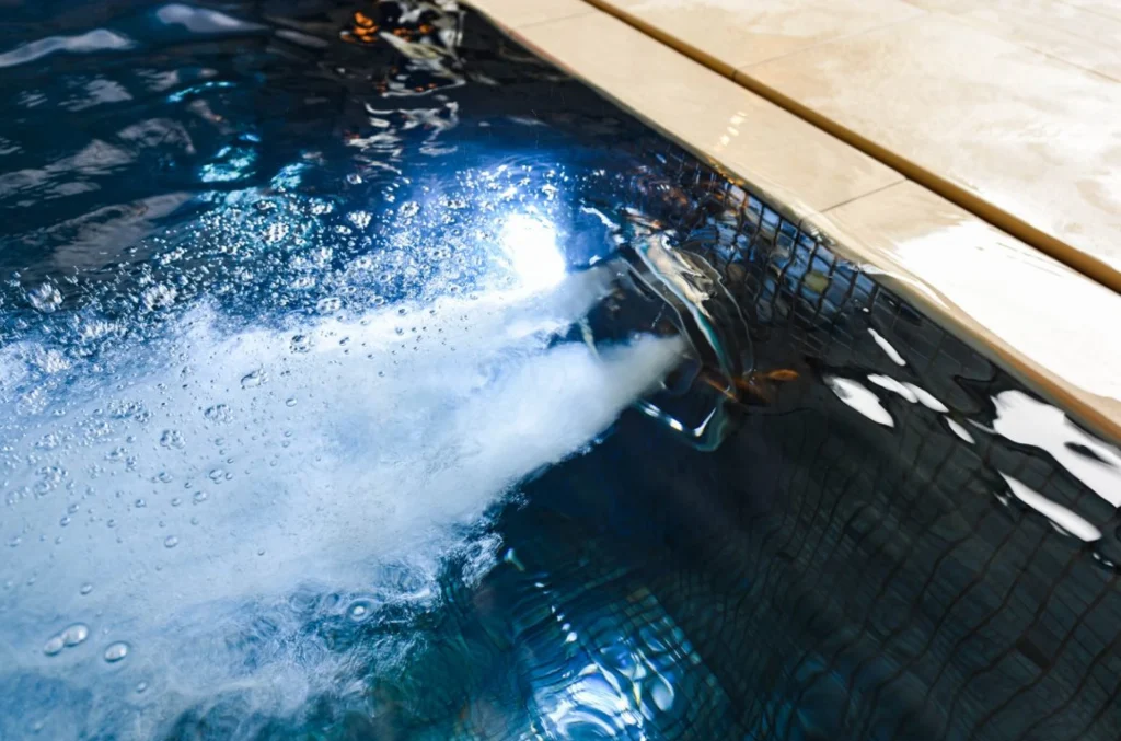 Hot tub with bubbling jets and wooden deck surround