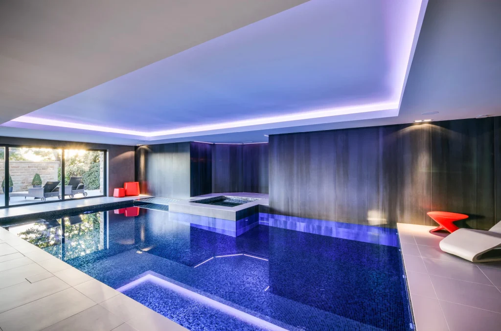 Modern indoor swimming pool with blue LED lighting