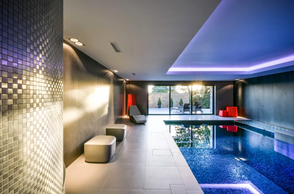 Modern luxury indoor swimming pool with ambient lighting