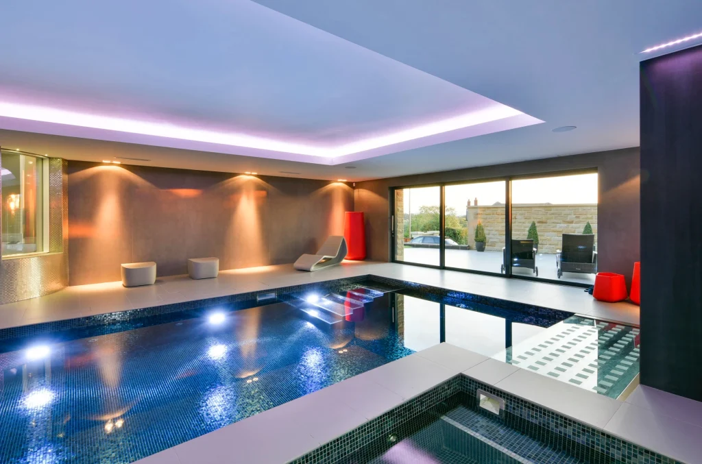 Modern luxury indoor swimming pool with ambient lighting
