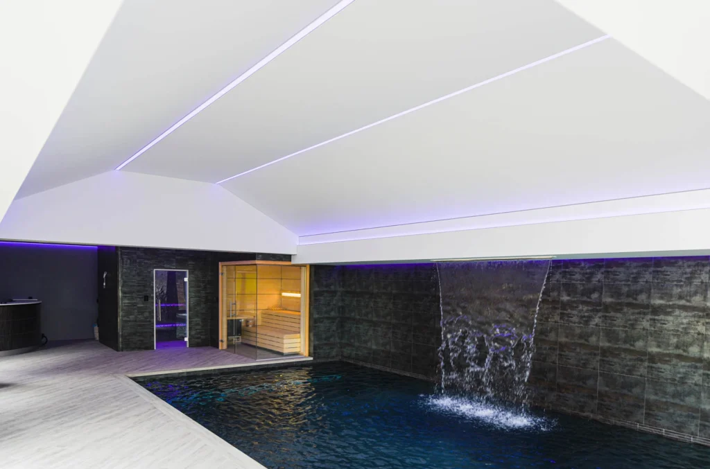 Modern indoor pool and sauna facility with LED lighting