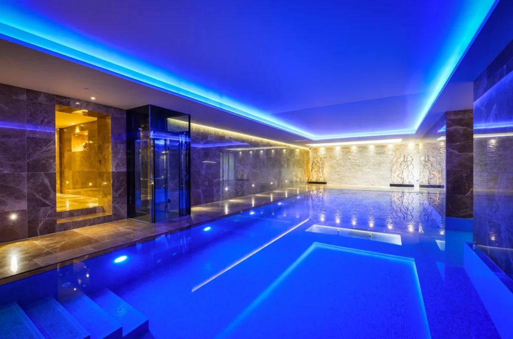 Luxurious indoor swimming pool with blue LED lighting